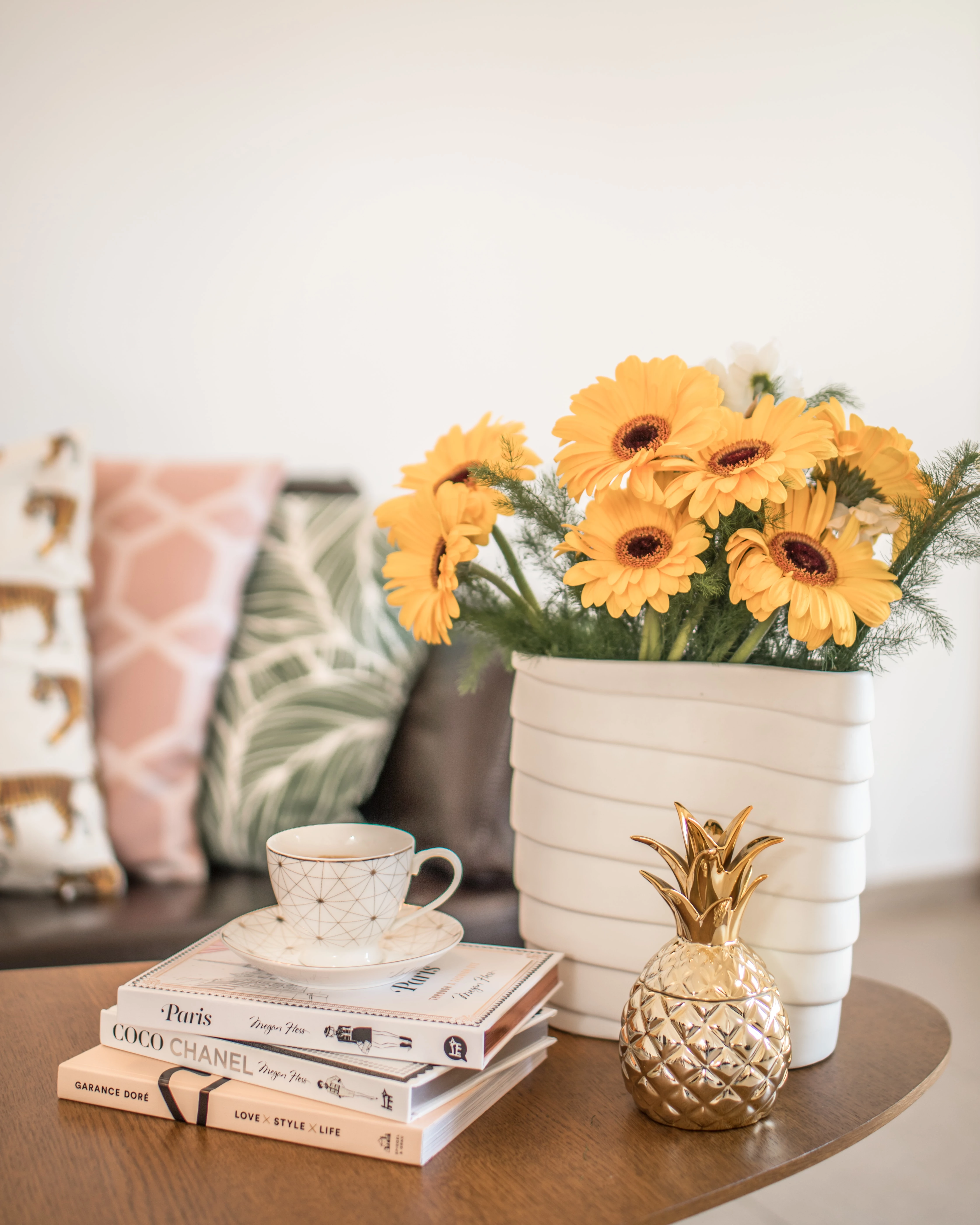 Yellow Flowers in a vase and books on a coffee table Yellow Flowers in a vase and books on a coffee table